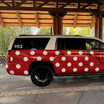 Disney Minnie Van transportation service suburban with red and white polka dots